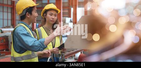 Industrial engineer man and worker operation woman training work on metal sheet ironing machine Stock Photo