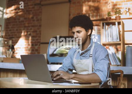 Man owner working and checking email on computer Stock Photo