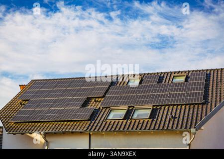 Photovoltaic panels on the roof of family house, solar panels. Environment and technology concepts. Stock Photo