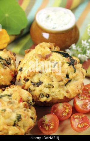 Fresh baked savory muffins with herb spread and cherry tomatoes Stock Photo