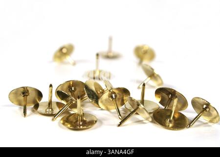 Scattered thumb tacks isolated on a white background Stock Photo
