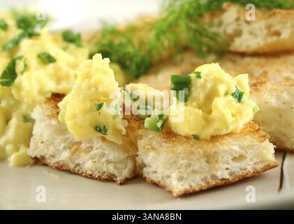 Scrambled eggs on turkish bread with shallots fennel and parsley Stock Photo