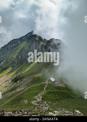 Breathtaking Majestic Mountain Landscape with Dramatic Clouds and Scenic Pathway Stock Photo