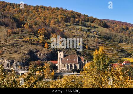 Wachau Valley, Austria - October 24, 2021: Wehrkirche St. Michael at the base of a hill in the Wachau Valley of Austria on a sunny autumn day. Stock Photo