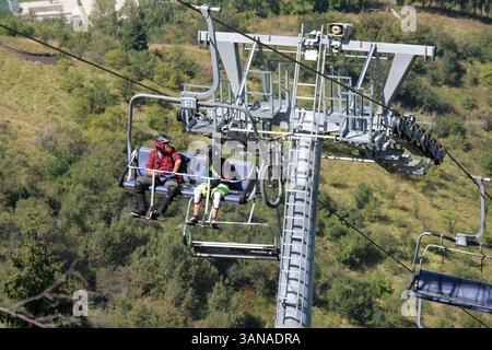 Cable car with open seats. People ride over the hills to the resting ...