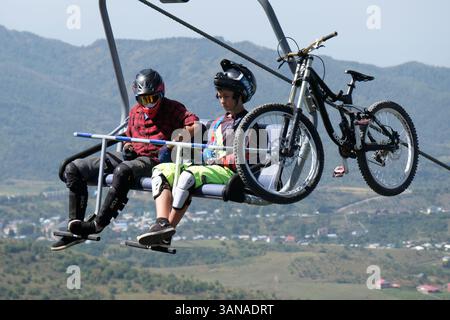 Cable car with open seats. People ride over the hills to the resting ...