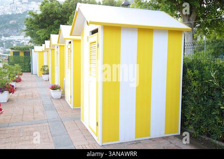 Striped yellow and white beach huts Stock Photo