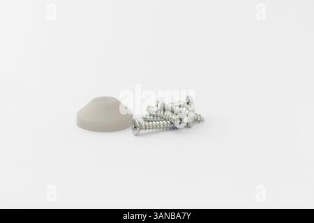 Mixed screws and plastic cap on isolated white background Stock Photo