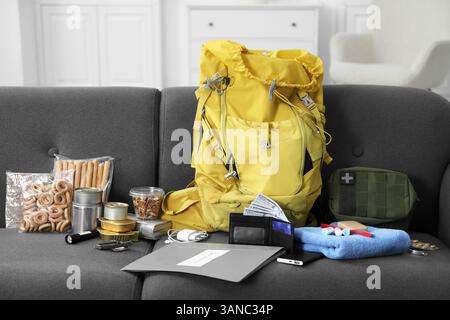 Survival kit. Different emergency supplies on sofa indoors Stock Photo