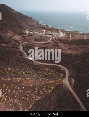 Aerial view of Playa de Las Cabras with winding road and wind turbines, Fuencaliente de La Palma, Spain. Stock Photo