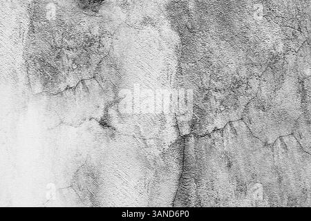 Cracked concrete wall showing signs of age and distress in monochrome Stock Photo