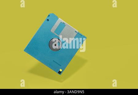 Vibrant Blue Floppy Disk on Minimalistic Yellow Background Stock Photo