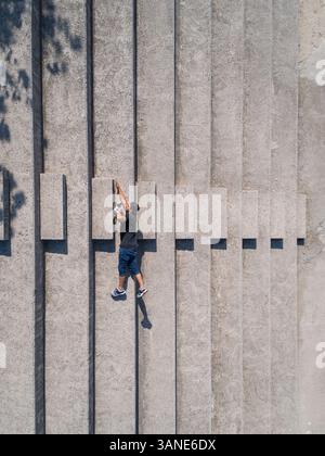 Aerial conceptual view of a man falling from a parking line in Dubai, U ...