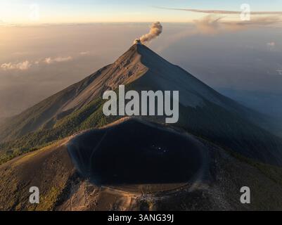 Aerial view of erupting Fuego volcano with smoke and ash clouds ...