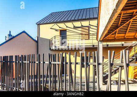 Modern metal barrier fence surrounding courtyard of new buildings - Loches, Indre-et-Loire (37), France. Stock Photo