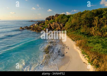 Aerial view of a person walking on the beach at Grand Anse, La Digue and Inner Islands, Seychelles. Stock Photo