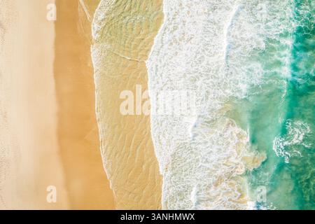 Aerial view of Sunshine Beach with ocean waves crashing on the sand along Alexandra Bay, Queensland, Australia. Stock Photo