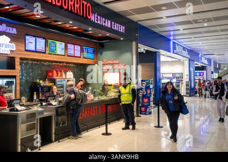 UK, England, Manchester Airport, Terminal 2 departure lounge, passengers in fast food catering area Stock Photo