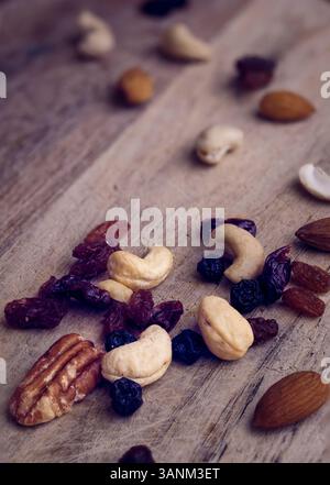 “Natural Essence: Dried Fruits and Nuts on Rustic Wood” Stock Photo