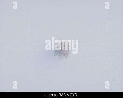 Aerial view of a minimalistic white textured wall with subtle patterns and clean design, Kaltenberg, Geltendorf, Bavaria, Germany. Stock Photo