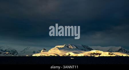Sunrise over mountains on the coast of Antarctica near Wilhelmina Bay. Stock Photo