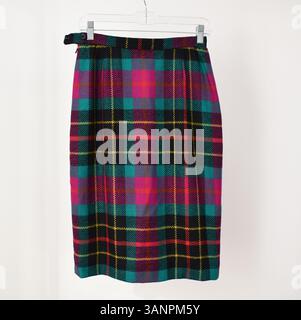 Scottish tartan skirt on hanger on white background. Stock Photo