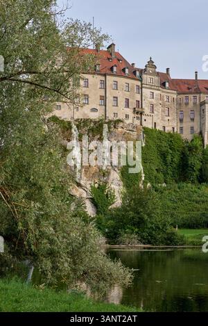 Majestic Sigmaringen Castle Perched on Rugged Cliff Above Tranquil Danube: Historic Hohenzollern Residence Showcases Medieval Architecture and Royal Stock Photo