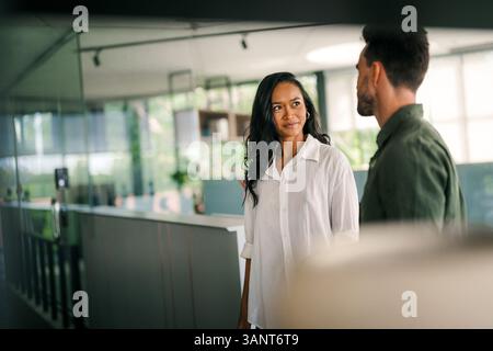 Cheerful diverse coworkers having fun during work break using technology enjoying working together Stock Photo