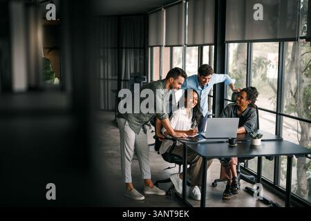 Mixed team of software engineers brainstorming ideas. Diverse app developers collaborating as group Stock Photo