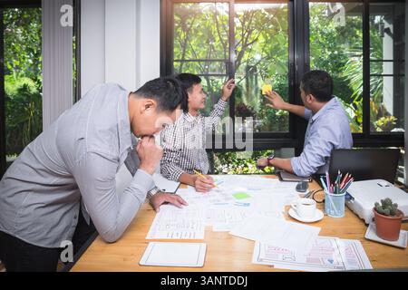 UX or UI designers designing on their smartphone application layout prototype project. Stock Photo