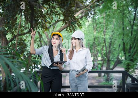 Confident team of female architect working together at terrace. They discussing about new startup project. Architect discuss with engineer about proje Stock Photo