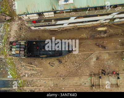 Aerial view of an industrial shipyard with workers and machinery along the riverbank, Subhadya, Keraniganj, Dhaka, Bangladesh. Stock Photo