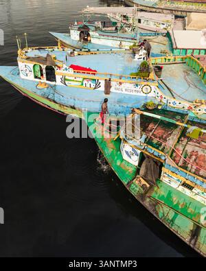 Savar, Bangladesh - 02 February 2025: Aerial view of busy boats and people working along the Buriganga river in a vibrant urban scene, Amin Bazar, Savar, Dhaka, Bangladesh. Stock Photo