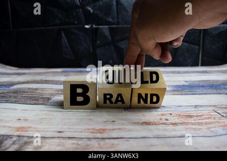 Concept word Build your brand symbol on wooden blocks on a wooden table Stock Photo