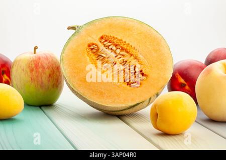 sliced cantaloupe fruit mix on wood background Stock Photo