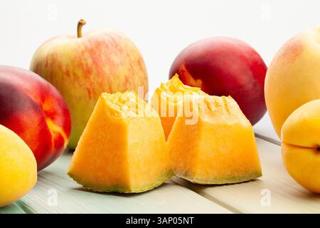 sliced cantaloupe fruit mix on wood background Stock Photo