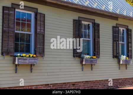 Close up of flower boxes under windows on the side of an old building in historical downtown Autumn Colors  in downtown historical Jonesborough, Tenne Stock Photo