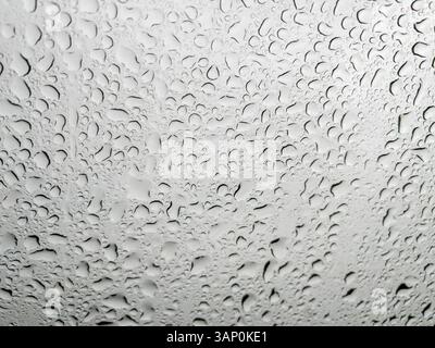 Raindrops on windshield, texture of drops of water rain on glass background Stock Photo
