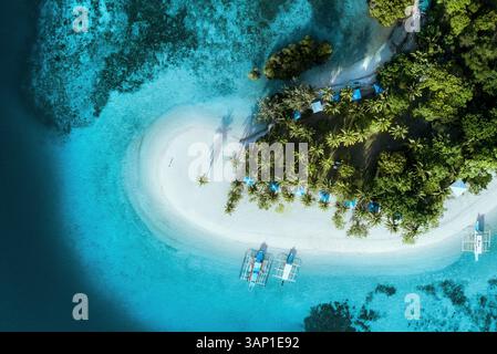 Aerial view of catamarans docked on a tropical beach at Pass Island, Busuanga, Coron, Palawan, Philippines. Stock Photo