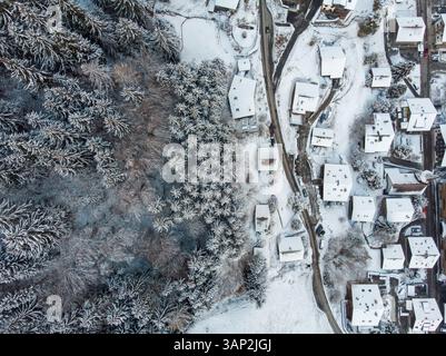 Aerial view of residential houses covered in snow in winter, Valais, Switzerland. Stock Photo
