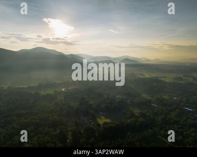Aerial view of hills, green fields and forest at sunrise, Chiang Mai, Chiang Mai province of northern Thailand. Stock Photo