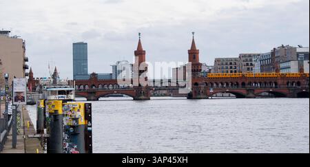 Classic panoramic view of famous Oberbaum Bridge with historic Berliner U-Bahn crossing the Spree river on a beautiful sunny day Stock Photo