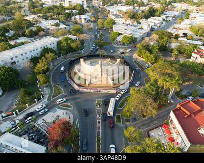 Aerial view of Paseo de Montejo, Monumento a la Bandera roundabout with traffic, trees, and shadows in evening, Merida, Yucatan, Mexico. Stock Photo