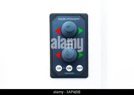 The control console of the bow and stern thrusters of a motor yacht with buttons and joysticks, close-up. Stock Photo