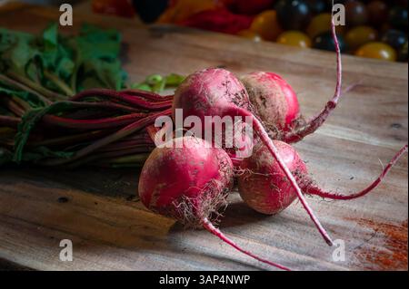 Freshly pulled beets on a wood cutting board Stock Photo