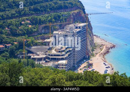 Unfinished Hotel "As" on Perazica Do beach near Budva along the coast of the Adriatic Sea in Montenegro - Abandoned construction site after concrete p Stock Photo