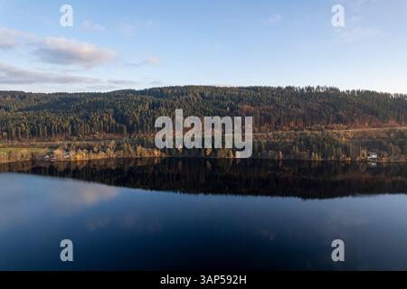 Aerial view of tranquil autumn scenery with serene reflections on a lake surrounded by lush trees in the Black Forest, Freiburg, Baden-Wurttemberg, Ge Stock Photo