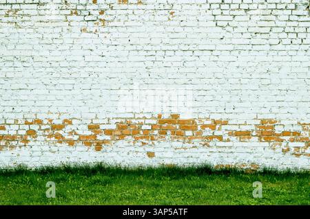 A brick wall is a sturdy structure made of bricks and mortar. It provides privacy, security, and aesthetic appeal to buildings. durability and timeles Stock Photo