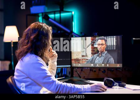 Computer science teacher doing online tutoring, telling student in online videocall about ways to fix computing bugs. IT professional teaching disciple in webinar how to do programming Stock Photo
