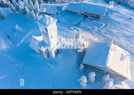 Aerial view of a snowcovered tower and ski hut in the mountains, Baden Wuerttemberg, Germany. Stock Photo